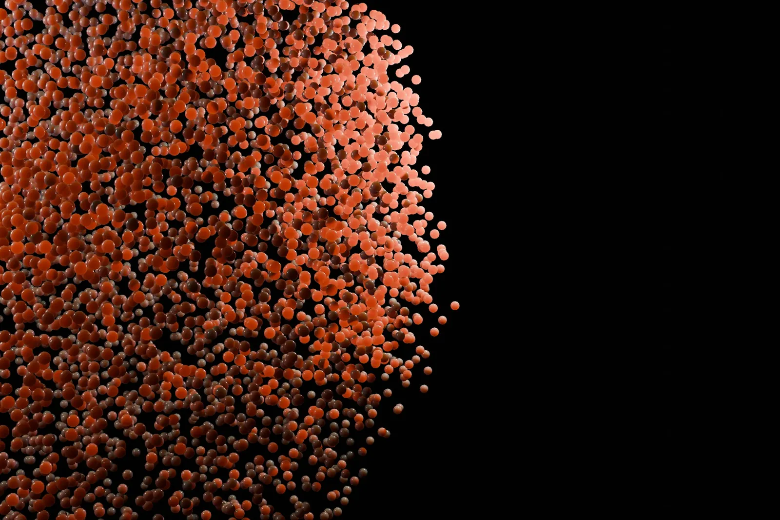Digital render of a dense cloud of small glossy orange spheres against a black background
